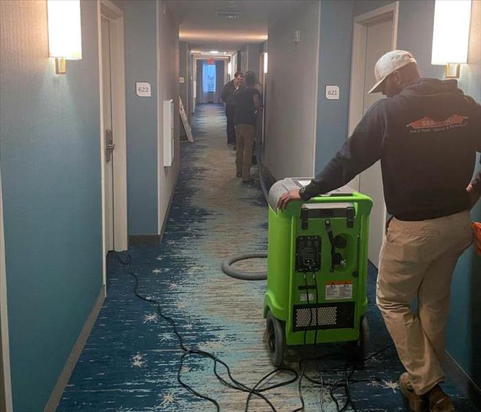 SERVPRO team drying water in hallway